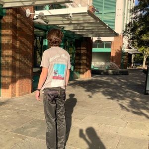 black very smooth fabric worn a few times with gold stitching,